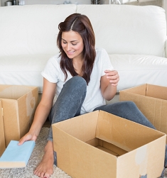 Girl packing books into the boxes